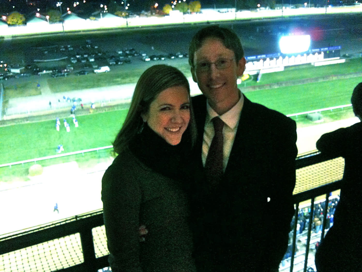 Robin and his wife on a balcony high above the track at Churchill Downs at night, the infield lit up behind them